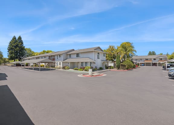 A sunny day at a residential complex with a clear blue sky.