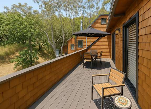 A wooden deck with a bench and a table.