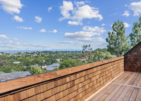A wooden deck overlooks a cityscape.