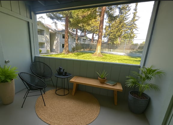 A balcony with a chair, table, and potted plants.