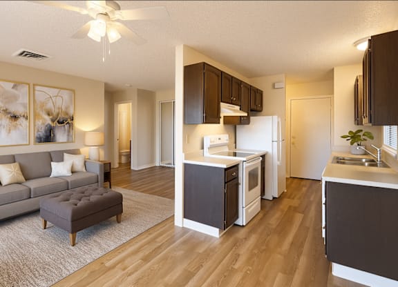 A modern kitchen with a refrigerator, sink, and cabinets.