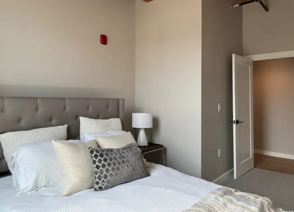 a bedroom with a bed and a door to a closet