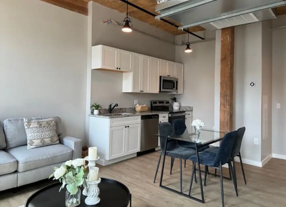 a kitchen and dining area with a table and chairs