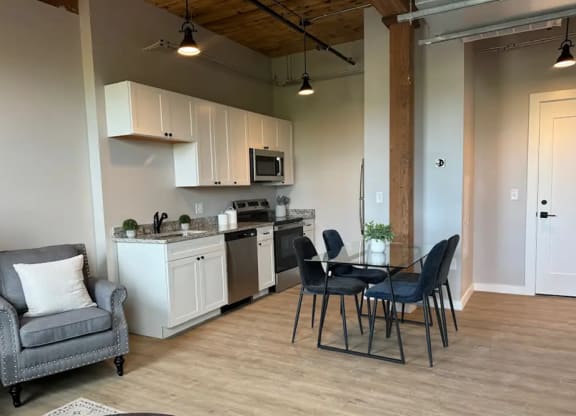 a kitchen and dining area with a table and chairs