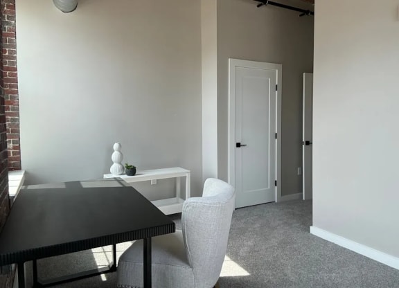 a dining room with a table and chairs and a door