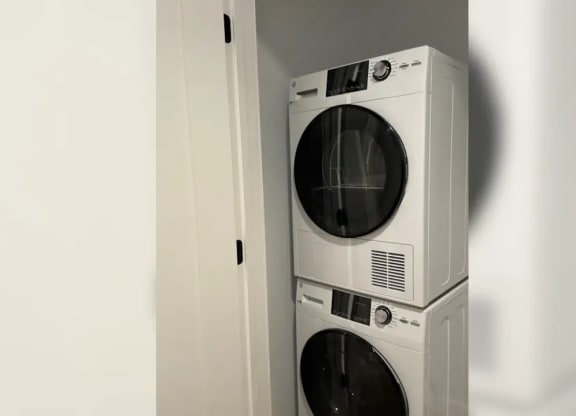 a white washer and dryer in a white room