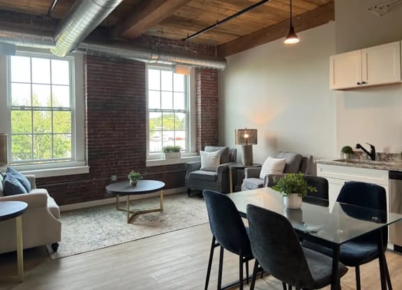 an open living room with a dining room table and a couch