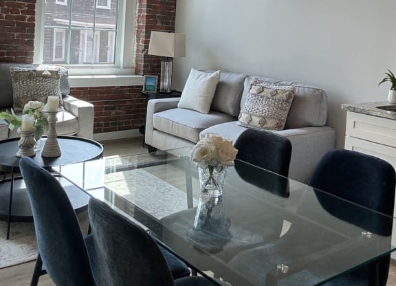 a living room with a glass table and a couch