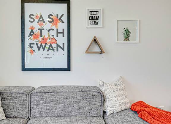 A grey couch with a grey cushion and a white pillow with a grey cushion and a grey cushion with a white pillow and a grey couch with a grey cushion and a white pillow and a