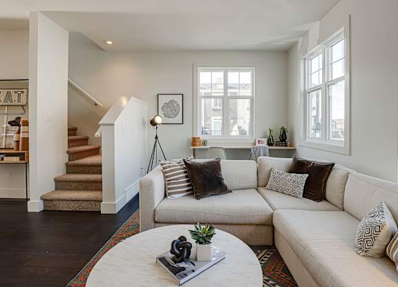 A living room with a white couch and a coffee table.