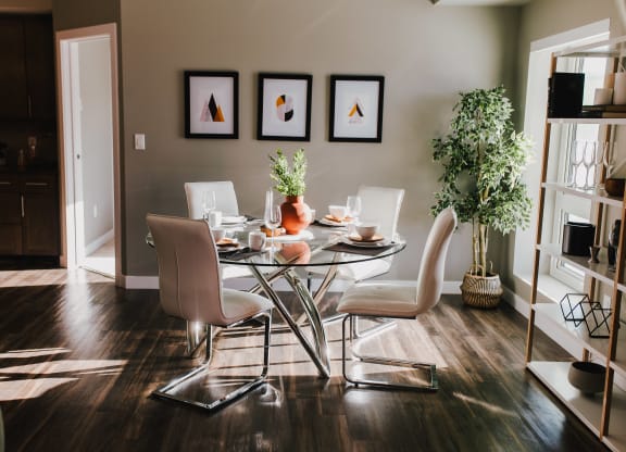 a dining room with a glass table and chairs