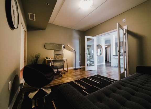 a living room with a couch and a chair and a staircase