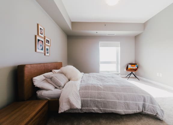 a bedroom with a bed and a large window