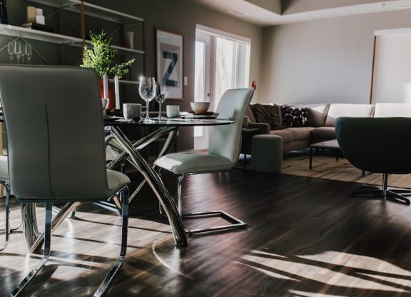 a living room with a dining room table and chairs