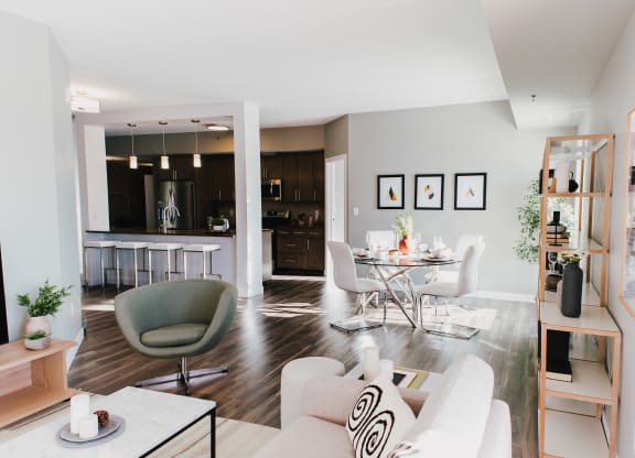 a living room and dining room with a table and chairs
