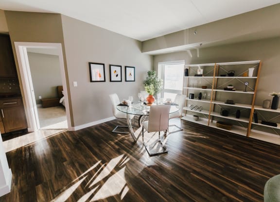 a dining room with a table and chairs and a book shelf