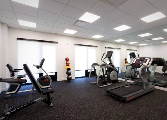 a gym with various exercise equipment in a large room