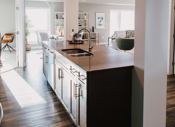 a large kitchen with a sink and a counter top