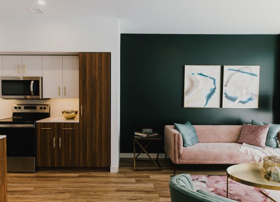 a living room with a couch and a kitchen
