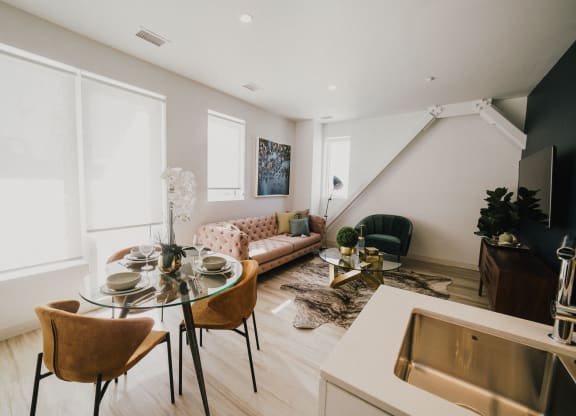 a living room and dining room with a table and chairs