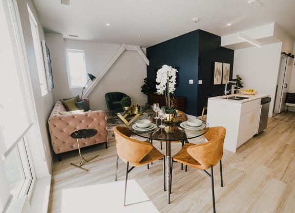 a living room and dining room with a table and chairs