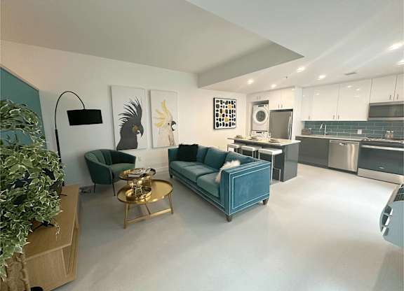 A modern living room with a blue couch and a coffee table.