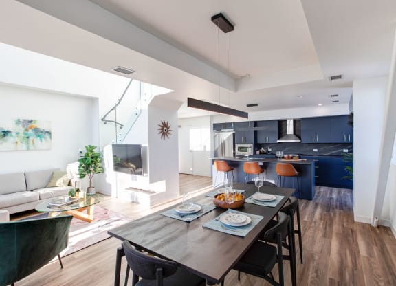 a living room and dining room with a table and chairs