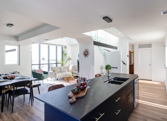 a kitchen with a large island and a living room