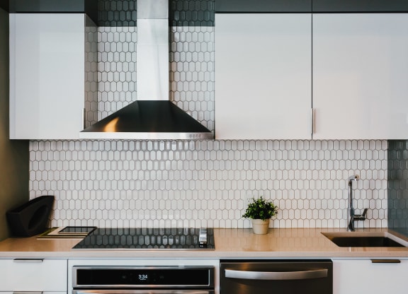 a kitchen with white cabinets and a sink