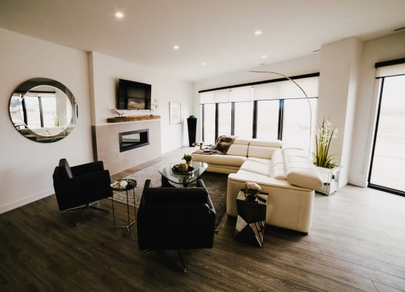 a living room with a couch and a chair and a fireplace