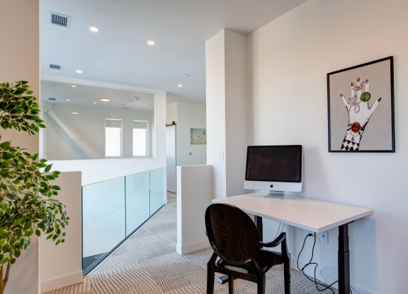 a home office with a computer on a desk