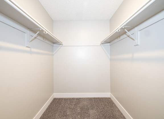 A small, empty room with a carpeted floor and white walls.