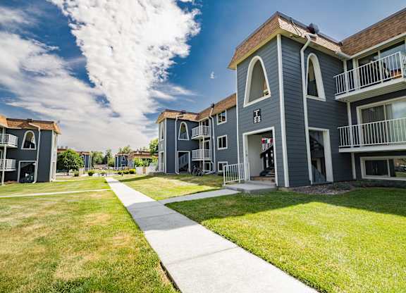 A sunny day at a residential complex with a clear blue sky.