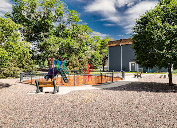 A playground with a slide, swings, and a climbing frame.