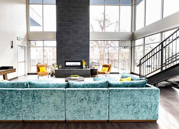 a large living room with a blue couch and a fireplace