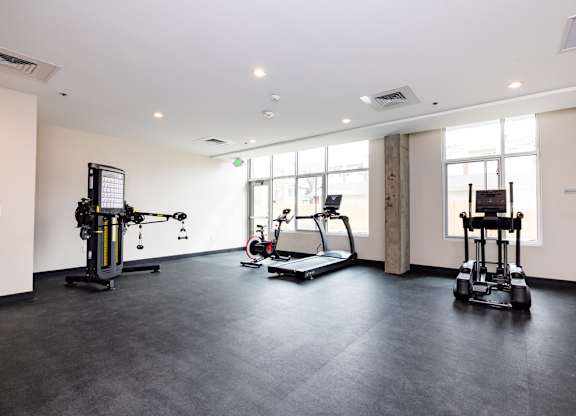 the gym has plenty of exercise equipment at the flats at west end apartments