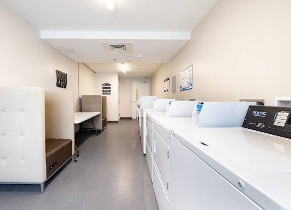 a room with a counter and a printer and desks