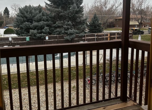 a deck with a view of a christmas tree
