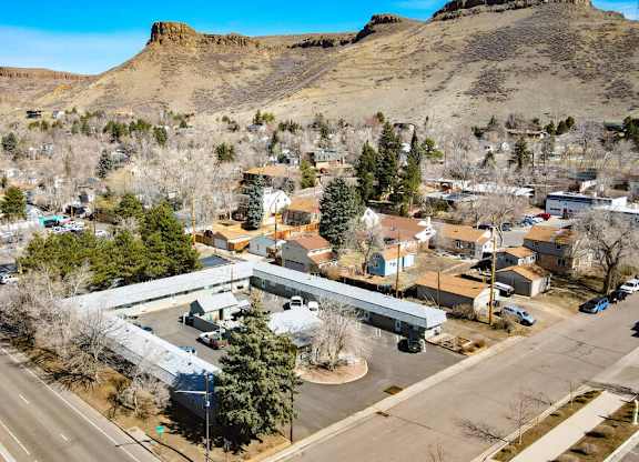 an aerial view of a building with a mountain in the background