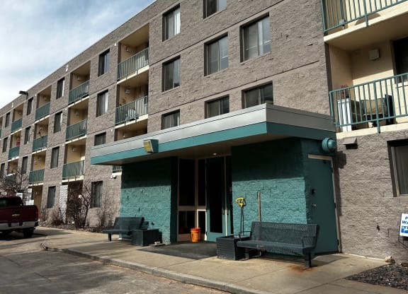a large apartment building with a green front entrance
