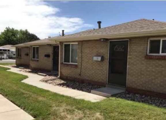 a brown house with the front door open