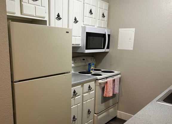 a kitchen with a stove microwave and refrigerator