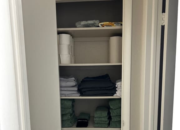 a closet with shelves filled with folded towels in it