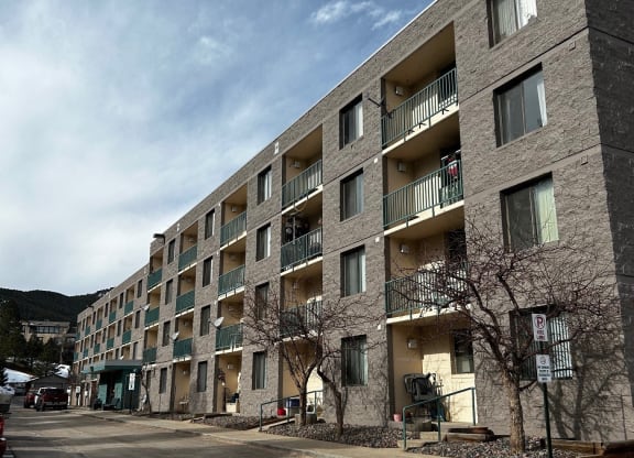 an empty street in front of an apartment building