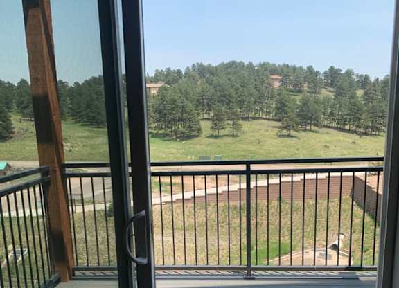 a balcony or terrace with a view of a field