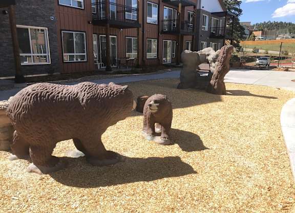 three bears statues in front of a building