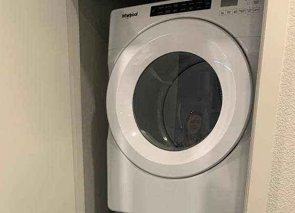 a washing machine and a dryer in a laundry room