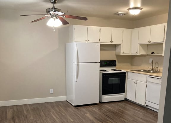 a kitchen with white cabinets and a refrigerator