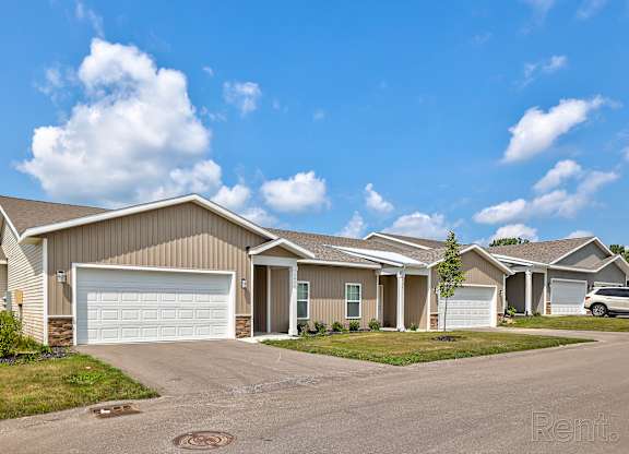 A row of houses with a clear blue sky above them.