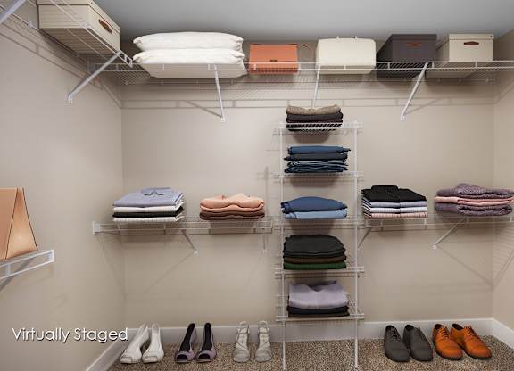 A closet with clothes and shoes neatly organized on shelves.